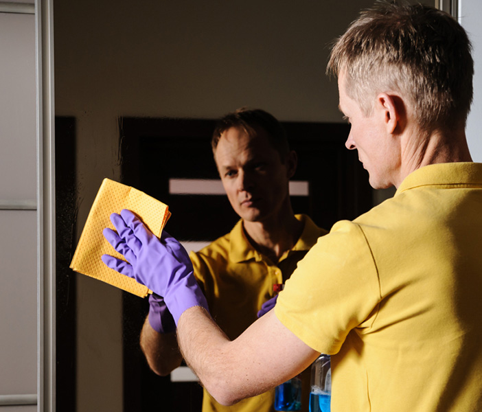 Man is cleaning the mirror