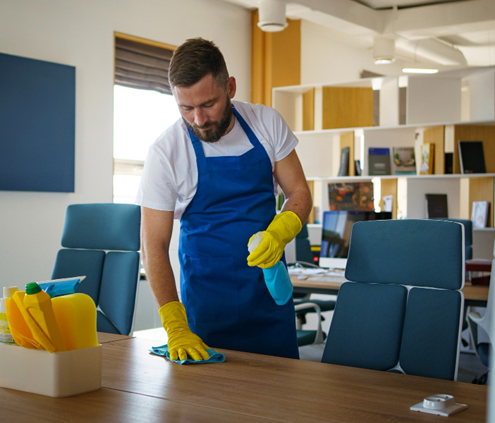 Man is cleaning the table in home